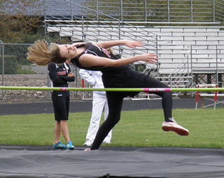 Brandi Gehring clears the bar in the high jump on the way to a first place finish.