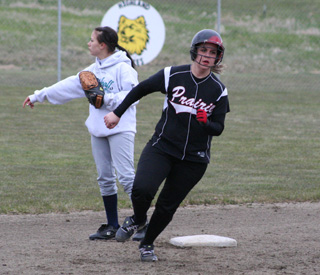 Haleigh Schmidt rounds second as she heads for third with a triple.