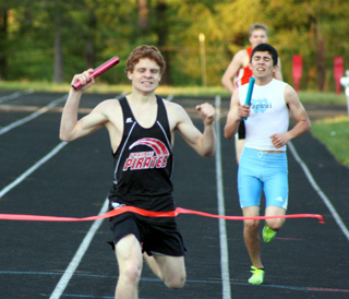 Brock Heath celebrates as he crosses the finish line first in the medley relay. He teamed with Josh Roeper, Dakota Wilson and Justin Schmidt in the event. Heath also won the 3200 and 1600.