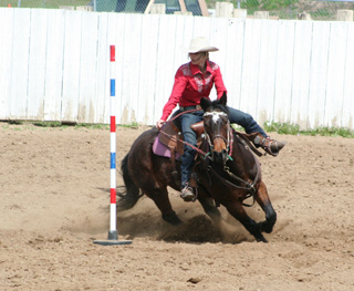 Callie Mader and her horse Jewels compete in the poles at the District Rodeo. Photo by Michelle Schaeffer.