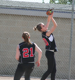 Leah Holthaus fields a pop up against Potlatch at District as Kendra Dinning comes in to back up the play.