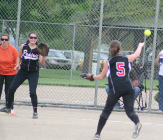 Pitcher Megan Sigler has fielded a comebacker and tosses the ball to first baseman Meaghan Bruner for an out against Troy.