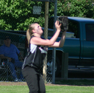 Kendall Schumacher is about to catch a fly ball to right in the first Genesee game.
