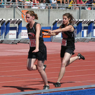 Shelby VonBargen hands off to Claire Whitley in the 4x200 relay where they finished in 2nd place.