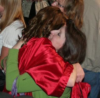 Kayla Johnson gets a hug from Kris Nida.