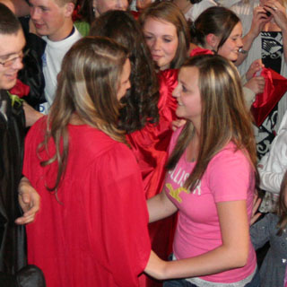 Shelby Duman receives congratulations from Taylor Heitman while Beka Bruner gives her sister Meaghan a congratulatory hug.