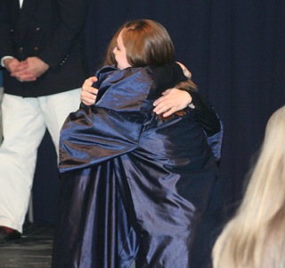 The first hug the graduates got after the ceremonies was from each other.