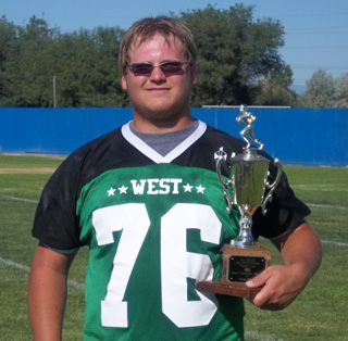 Colton Nuxoll poses with the All-Star Game championship trophy. His West team beat the East team 20-16 in the 8-man all-star game. Photo by Monica Nuxoll.