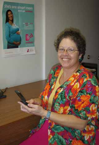 Sr. Janet Barnard, SMHC/CVHC Mission Director, demonstrates how to use a cell phone to enroll in a new national program, Text4Baby, which sends educational text messages to pregnant women and to parents during the babys first year of life.