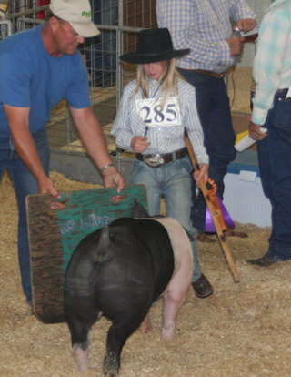 Tristan Yocum with her grand champion hog.