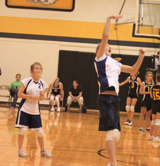 Kayla Schumacher spikes the ball at the Jamboree at Highland as Courtney Schwartz watches.