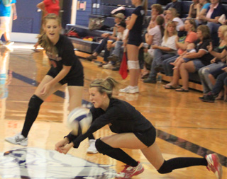 Leah Holthaus digs up a serve during the Jamboree at Grangeville last Tuesday. Watching is Tanna Schlader.