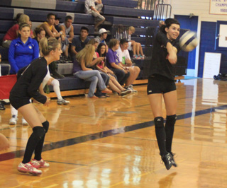 Sam Poxleitner makes a pass as Leah Holthaus watches during Prairies match against C.V. at the Jamboree.