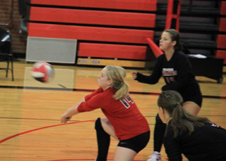 Demetria Riener makes a pass in the Summit match. Also shown are Stephanie Gimmeson (in back) and Monica Lustig.