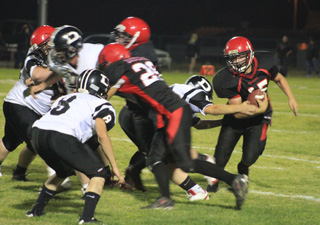 Garrett Schmidt evades a tackler as Levi Lustig provides a block.