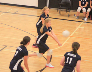 Kayla Schumacher makes a pass in the championship match between Summit and Kamiah. Other Summit players from left are Megan Rehder, Nicole Wemhoff and Nicole Frei.