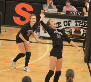 Leah Holthaus goes for a spike against C.V. At left is Tanna Schlader.