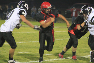 Tailback Levi Lustig bursts through a hole created by Prairie blockers. Blocking at right is Josh Zigler.