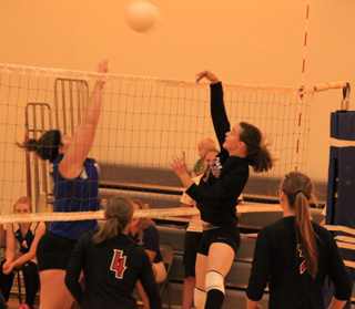 Monica Lustig hits the ball over an Orofino blocker. Also shown are Megan Sigler, 4, and MeShel Rad, 3.