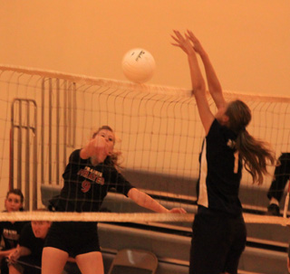 Tanna Schlader tries to get a spike past her cousin Savanah Prigge in the Prairie vs. Summit match at the Kendrick Tournament.