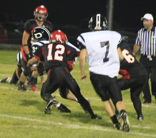 Tim Frei, who had a great game on defense, tackles a Deary ballcarrier after Dakota Wilson, #6 at right, slows him down by grabbing onto his jersey.