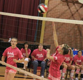 Leah Holthaus spikes the ball in the Kamiah match. Monica Lustig is at left.