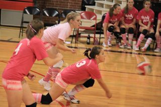 Stephanie Gimmeson goes for the dig against Kamiah. At left is Megan Sigler and in the back is Demetria Riener.