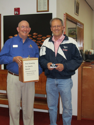 Jim Rehder, right,  won the sports watch at the Museum’s free day. He is shown with Sam Couch, museum director.