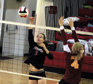 Monica Lustig sends a spike down the line in the Dayton match as the defender expects a hit toward the middle.
