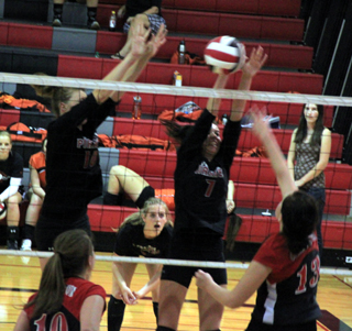 Tyler Workman and Sam Poxleitner walled off this Clarkston spike attempt. In the background is Tanna Schlader.