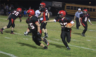 Cody Schumacher tells Josh Roeper who to block on what turned out to be a 26 yard touchdown run. In the background are Josh Zigler, 75, Justin Schmidt and Troy Lorentz, 8.