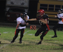 Justin Schmidt stiffarms a Kendrick defender on his big punt return that led to Prairies only touchdown against Kendrick.