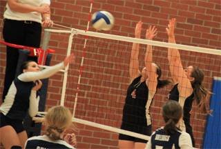 Megan Sigler and MeShel Rad go for a block against Grangeville at the Genesee Tournament.