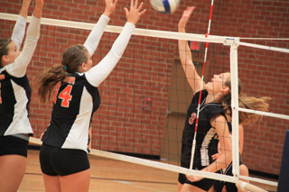 Tanna Schlader tries to get the ball by a pair of Pomeroy blockers at the Genesee Tournament.