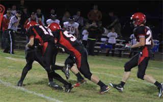 Tim Frei and Josh Roeper gang up on a Kendrick ballcarrier as Justin Schmidt comes in from the right.