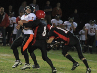 Troy Lorentz wraps up Kendricks quarterback as Tim Frei comes in to help finish off the play.