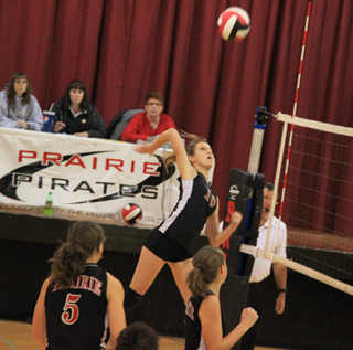 Leah Holthaus goes up for a spike against Potlatch. Also shown are Monica Lustig and Megan Sigler.