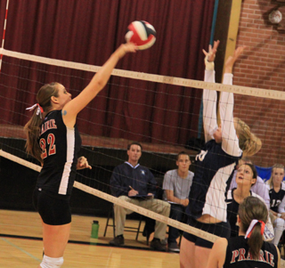 MeShel Rad spikes the ball past a Grangeville blocker. Bottom right is Megan Sigler.