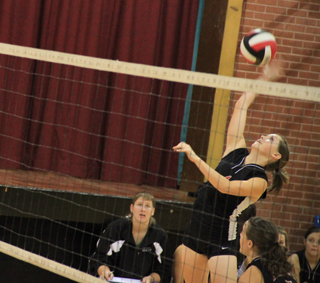 Megan Sigler spikes the ball against Potlatch. Monica Lustig, who set the ball, can be seen lower right.