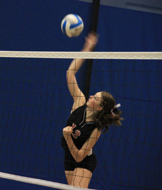 Tyler Workman pounds a spike against C.V.