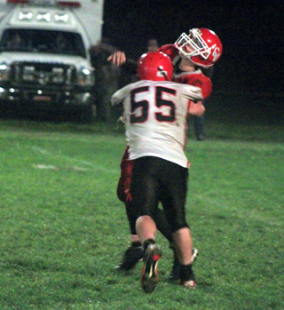 Josh Roeper hits the CV quarterback justs as he throws.
