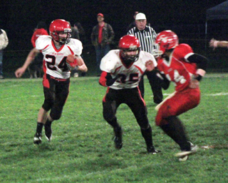 Cody Schumacher blocks a CV defender as Justin Schmidt carries the ball.