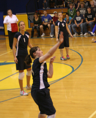 Nicole Frei hits the ball over against Nezperce as Savanah Prigge and Rachael Frei watch. Photo by Steve Wherry.