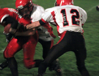 Tim Frei and Justin Schmidt tackle a C.V. ballcarrier.