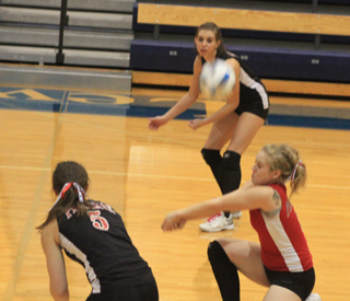 Demetria Riener makes a pass in the Hagerman match at State. At left is Monica Lustig and Sam Poxleitner is in the background.