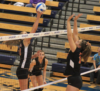 MeShel Rad tips the ball past a Hagerman blocker as Sam Poxleitner watches.