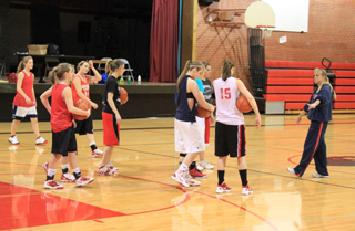 Coach Lori Mader describes the next drill for her players.