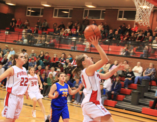 Megan Sigler scores a lay-up after a Nezperce turnover. Also shown are MeShel Rad and Shelby VonBargen.