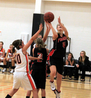 Tanna Schlader goes for a layup as Callie Mader sets a pick to block off a defender in the Kendrick game.
