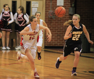 MaKayla Schaeffer foes after a loose ball. She wound up taking it down the floor for a lay-up attempt and converted 2 free throws when she got fouled. In the background is Callie Mader.